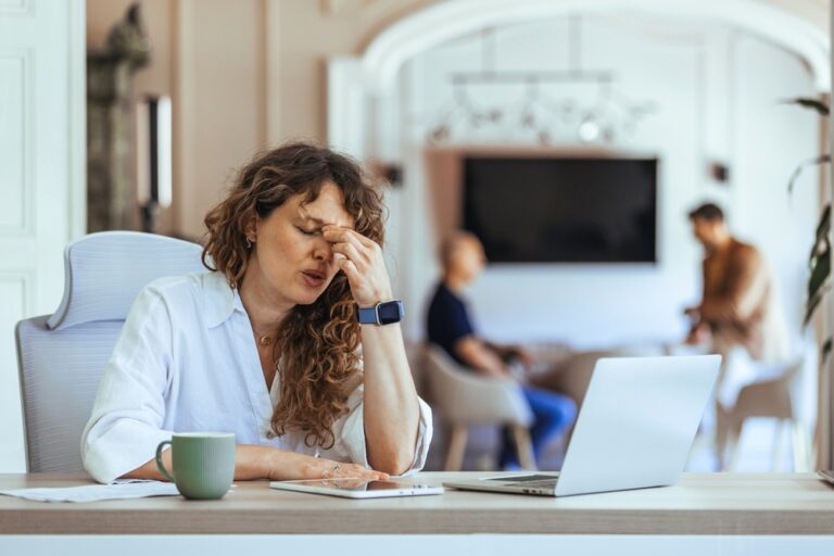 A woman sits at a desk in a stylish office