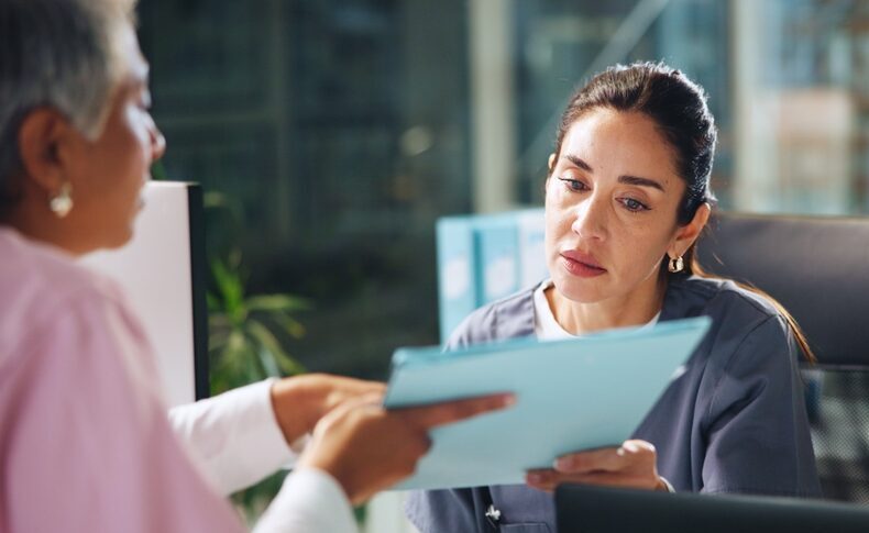 Women discussing paperwork