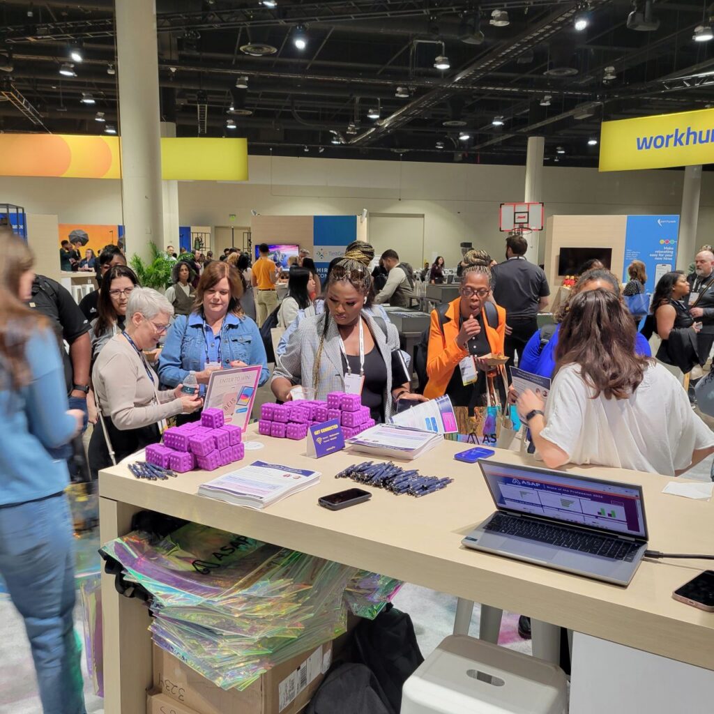WorkHuman Live conference attendees engaging with ASAP's booth