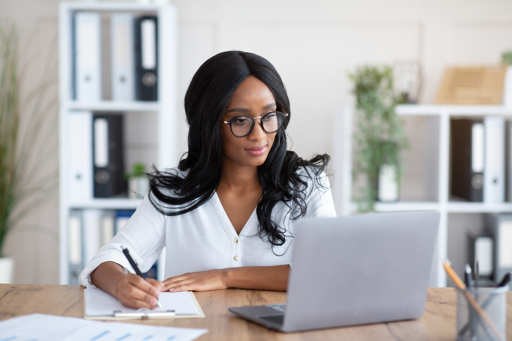 Business lady working on laptop at office.