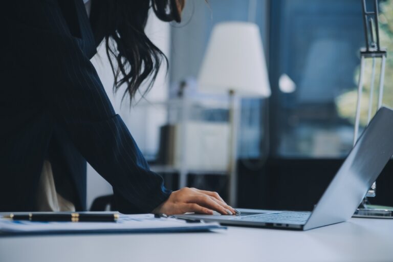 Young attractive businesswoman working on her project with laptop computer in modern office room
