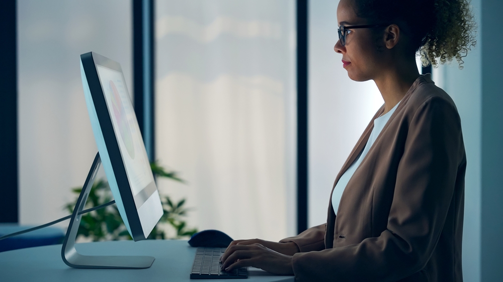 Black woman working with desktop computer in office